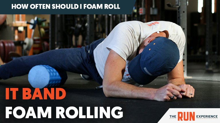 man foam rolling IT band