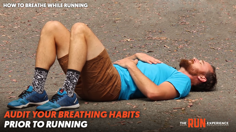 Man laying on ground with hand on chest and belly