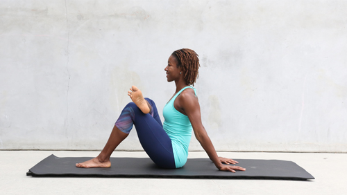 woman doing seated 4 figure stretch